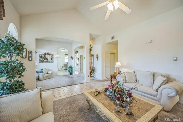 a living room with furniture and a chandelier