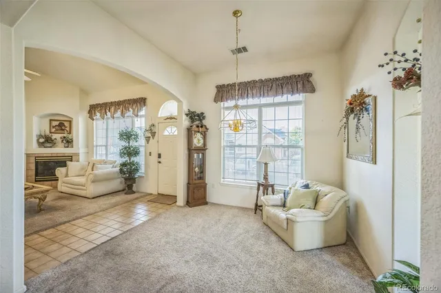 a living room with furniture and a chandelier