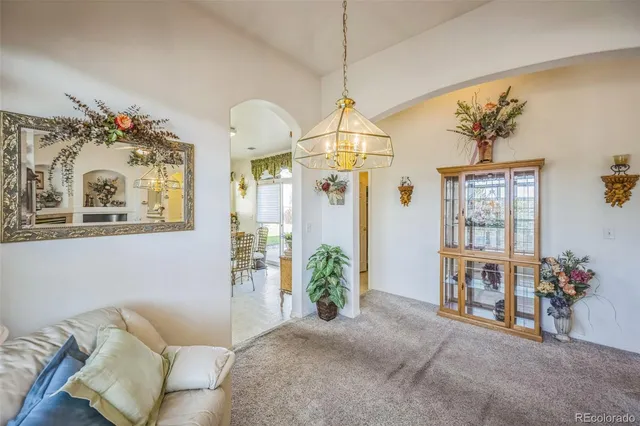 a living room with furniture and a chandelier
