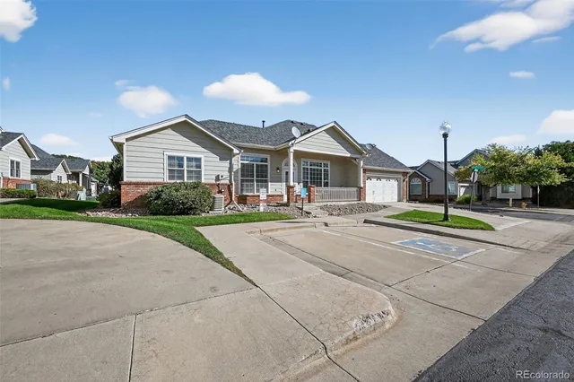 a view of a house with a big yard and large trees
