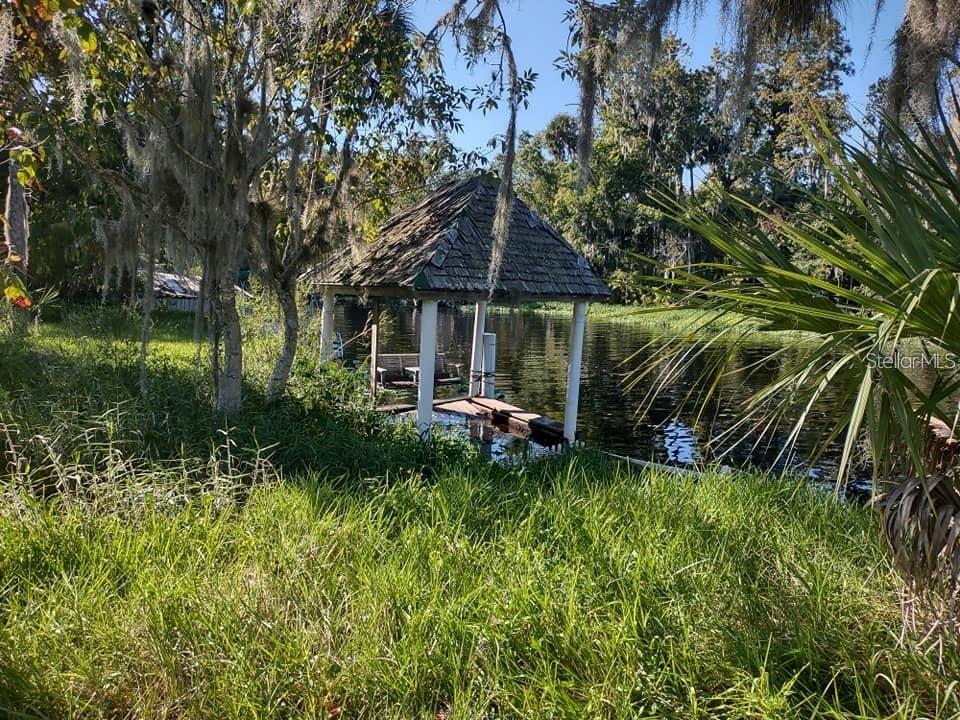 56544 Pecan Road Astor, FL 32102 - Photo 8 of 18 a view of a house with a backyard and sitting area