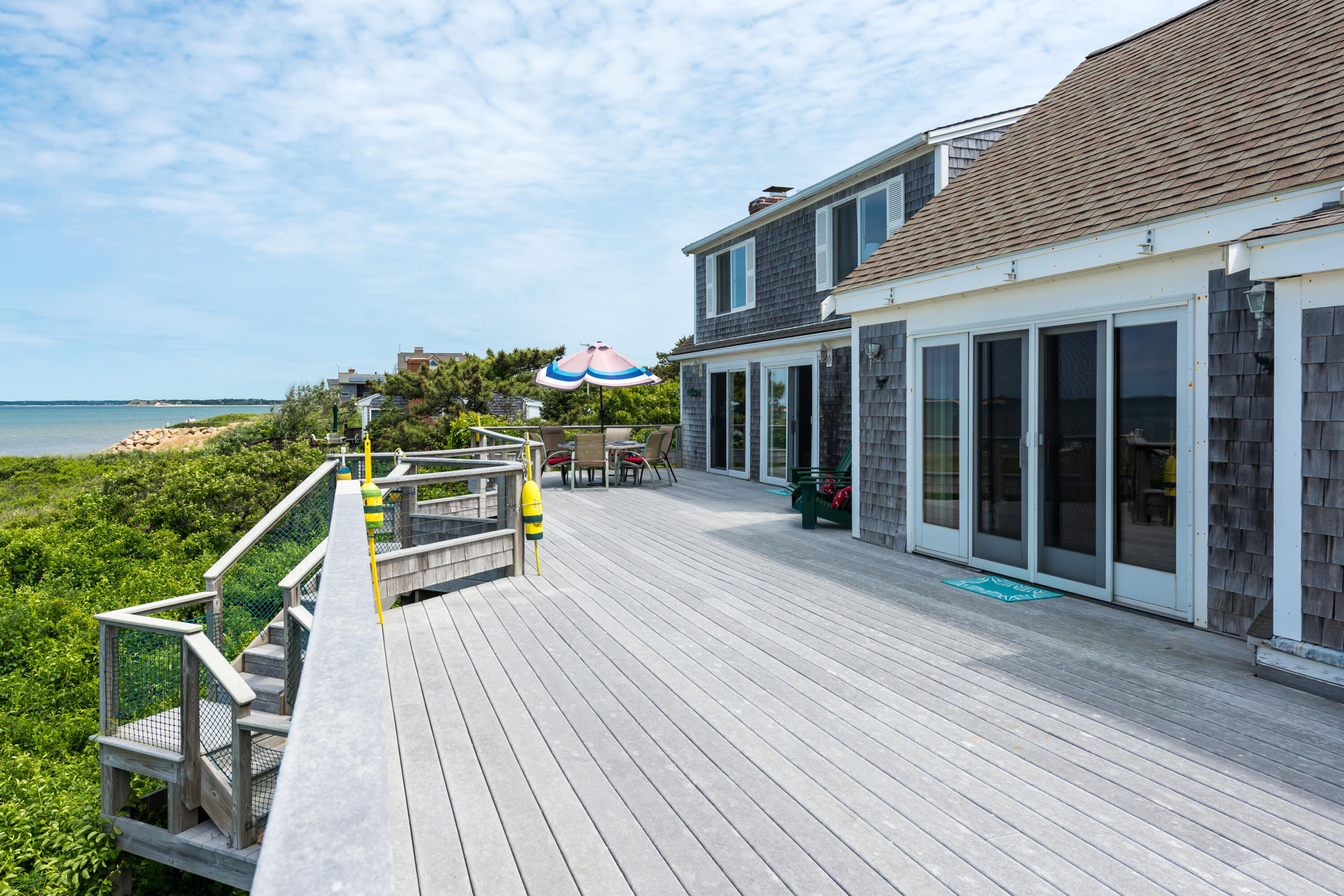 85 Sparrow Road Eastham, MA 02642 - Photo 11 of 43 a view of a house with wooden deck