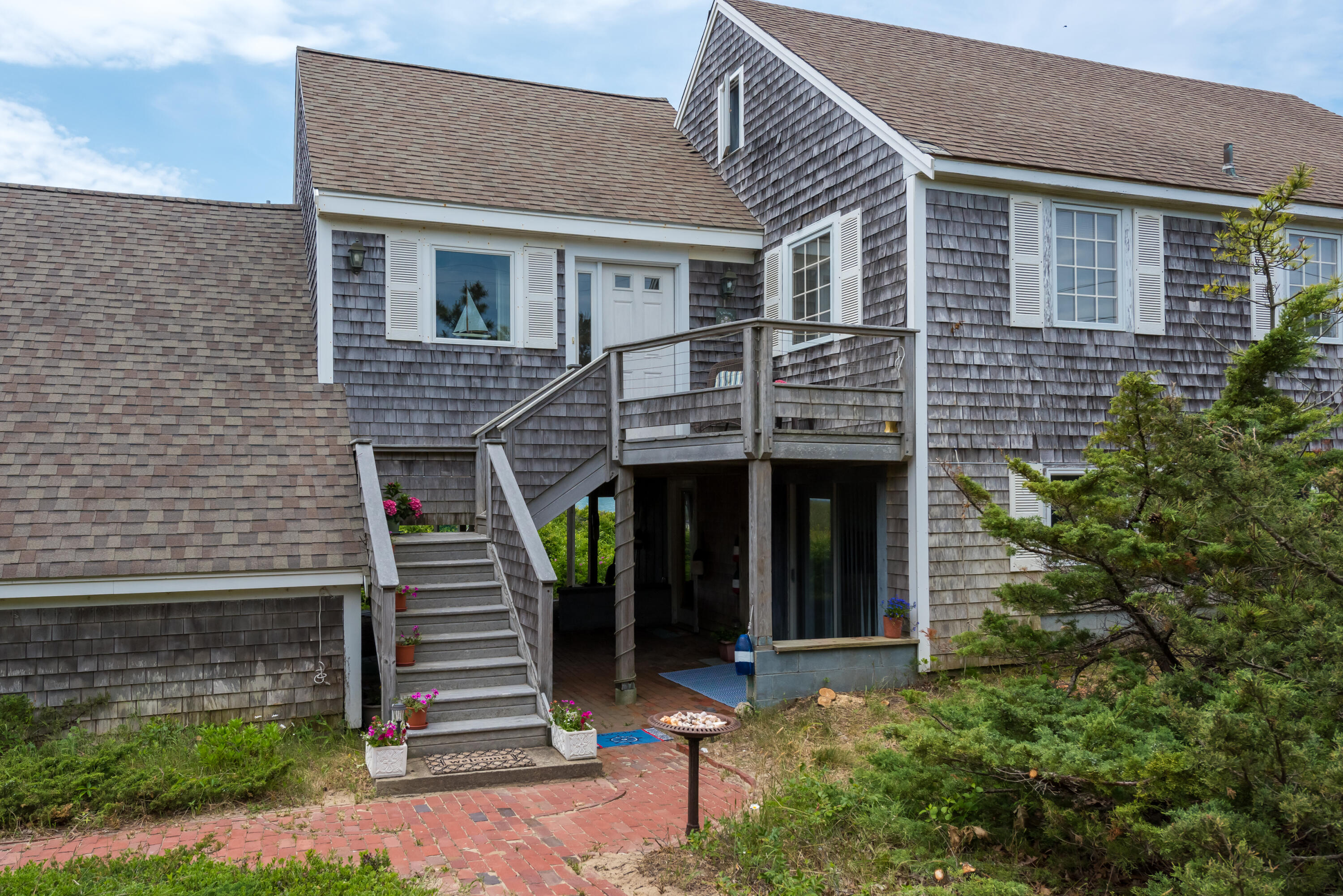 85 Sparrow Road Eastham, MA 02642 - Photo 12 of 43 a front view of a house with a garden