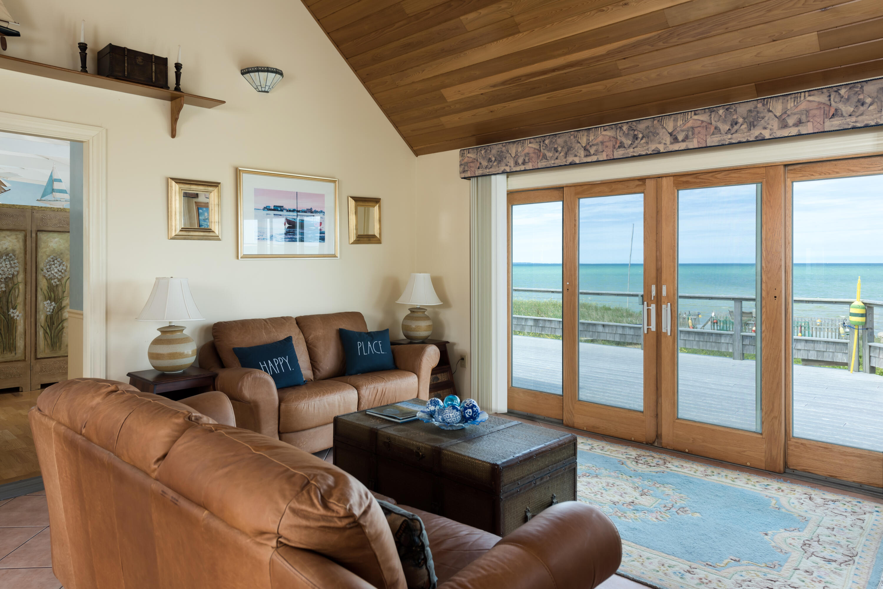 85 Sparrow Road Eastham, MA 02642 - Photo 14 of 43 a living room with furniture and a floor to ceiling window