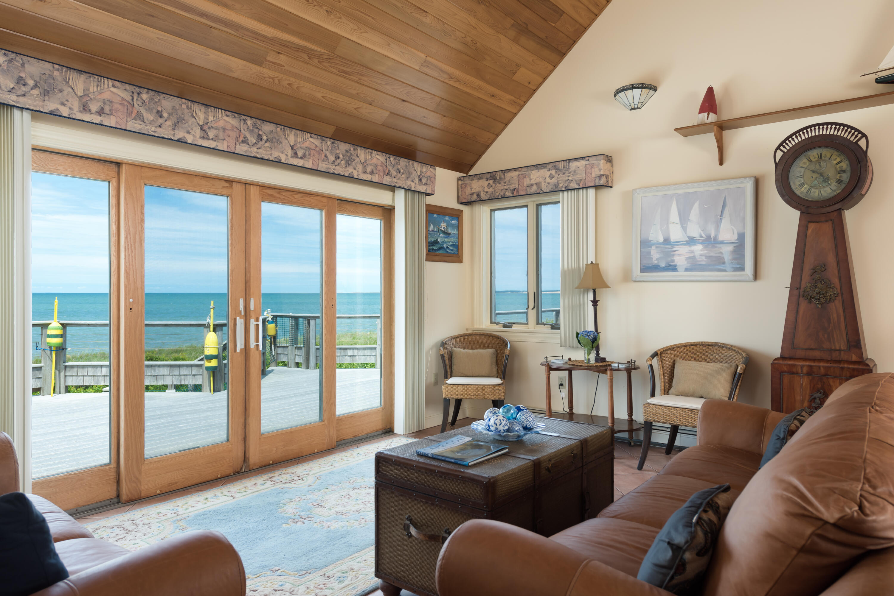 85 Sparrow Road Eastham, MA 02642 - Photo 15 of 43 a living room with furniture and a floor to ceiling window