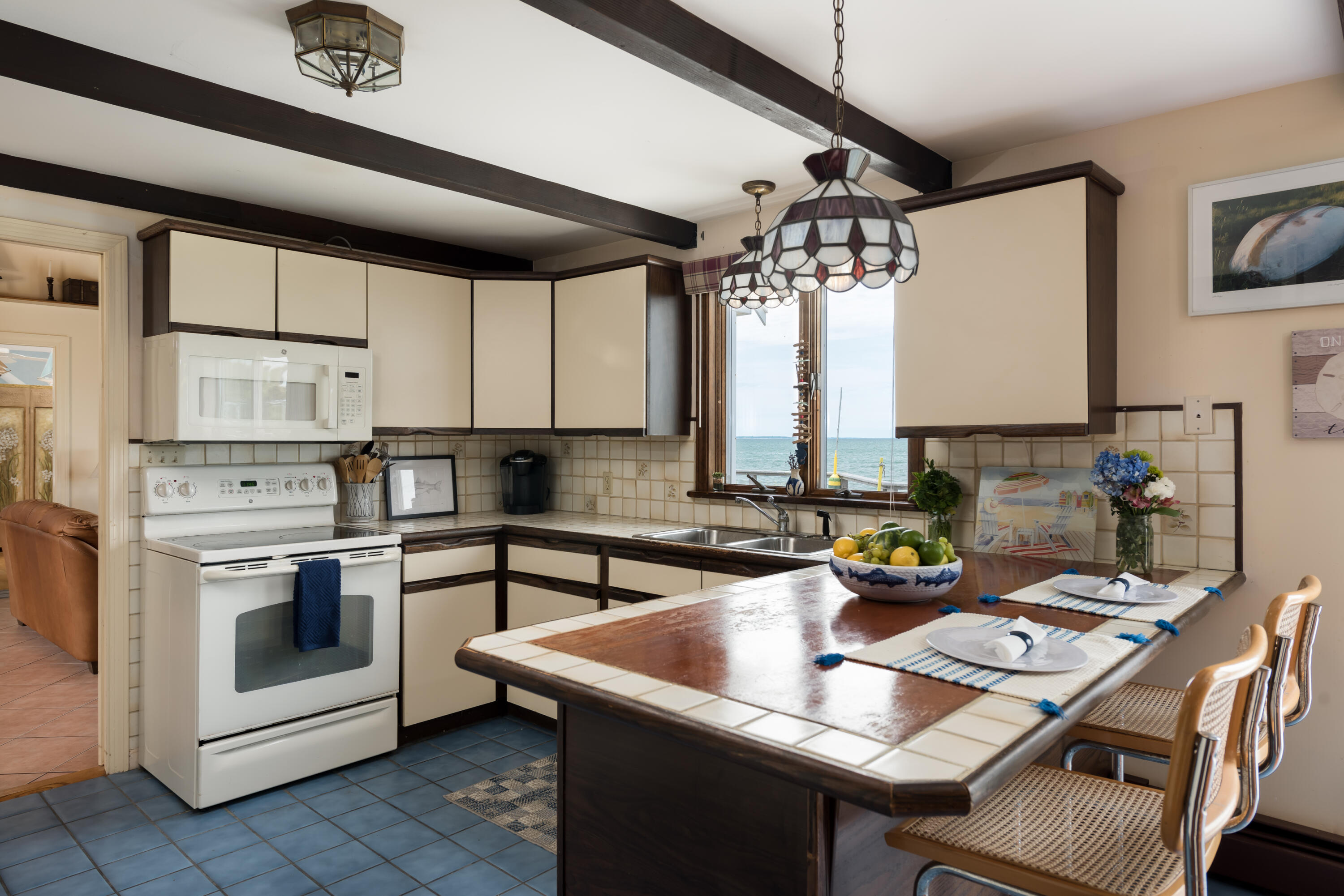 85 Sparrow Road Eastham, MA 02642 - Photo 21 of 43 a kitchen with a stove a sink and a refrigerator