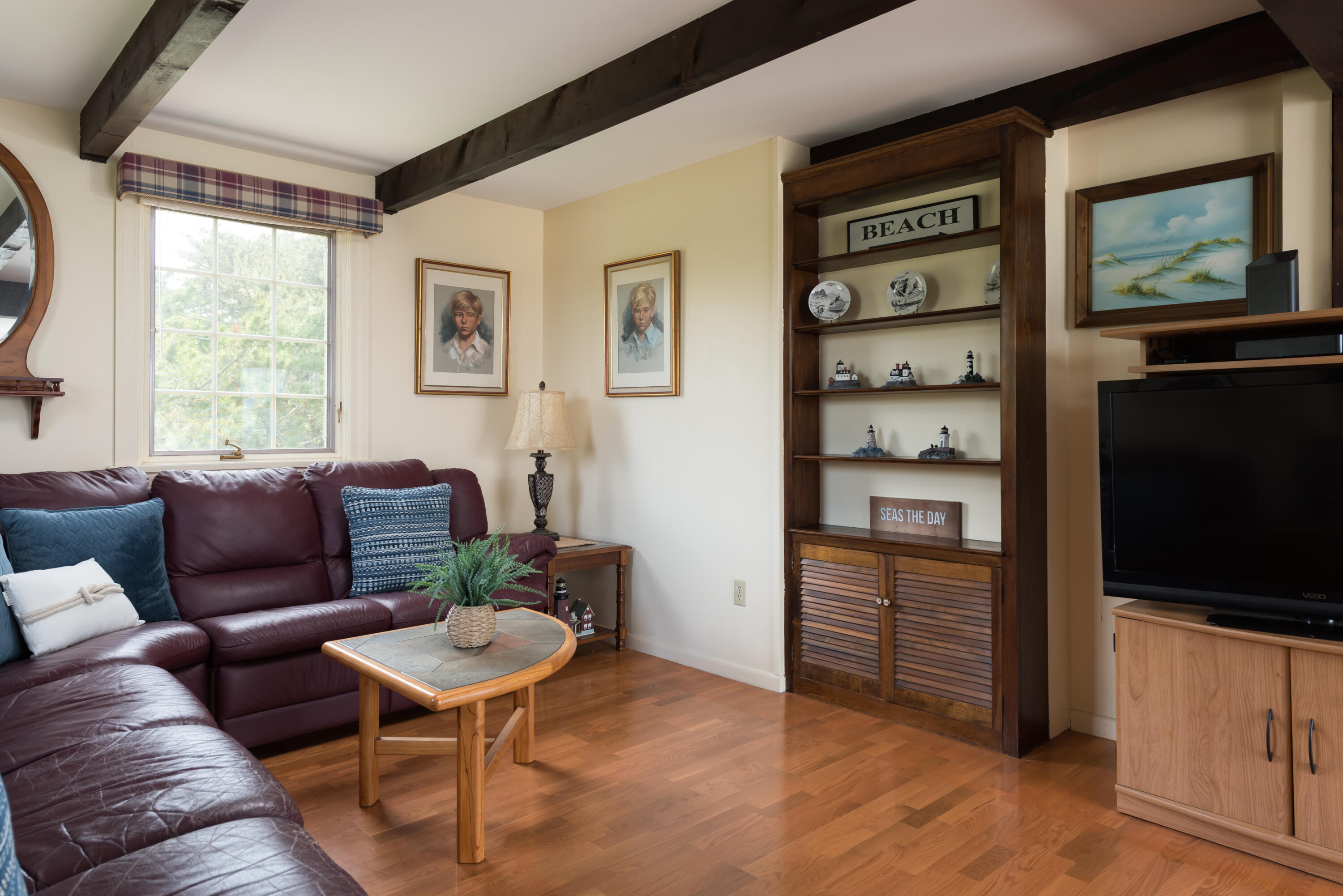 85 Sparrow Road Eastham, MA 02642 - Photo 25 of 43 a living room with furniture a flat screen tv and kitchen view