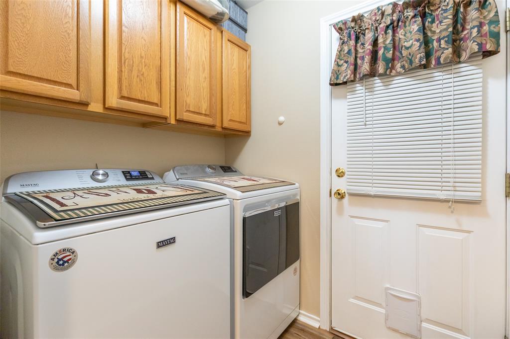 1603 Derrick Drive Haskell, TX 79521 - Photo 13 of 37 a view of washer and dryer with kitchen view