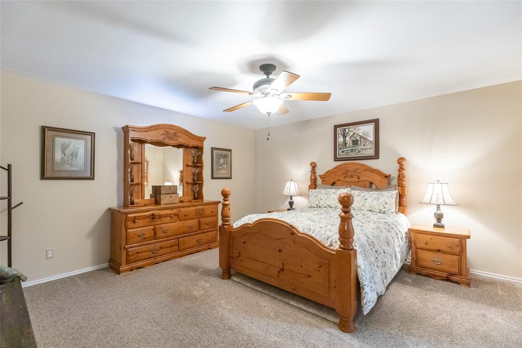 1603 Derrick Drive Haskell, TX 79521 - Photo 14 of 37 a bedroom with a bed and a chandelier