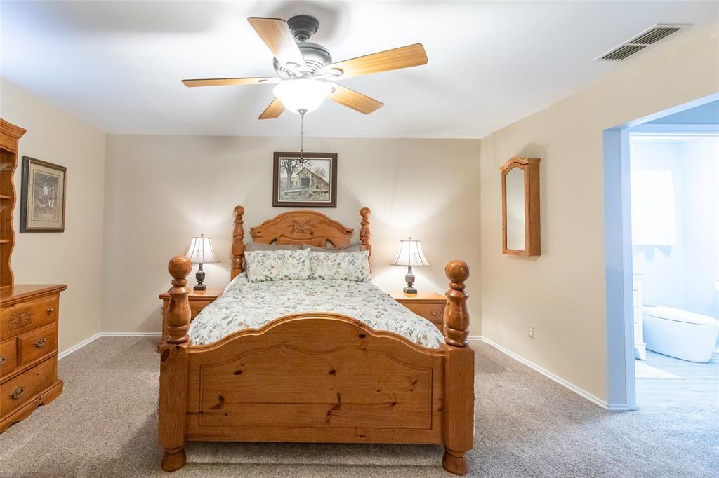 1603 Derrick Drive Haskell, TX 79521 - Photo 15 of 37 a room with a bed and a chandelier