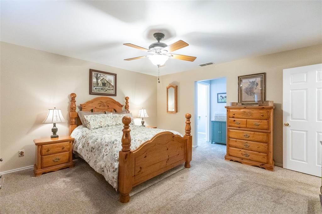 1603 Derrick Drive Haskell, TX 79521 - Photo 16 of 37 a bedroom with a bed and a chandelier