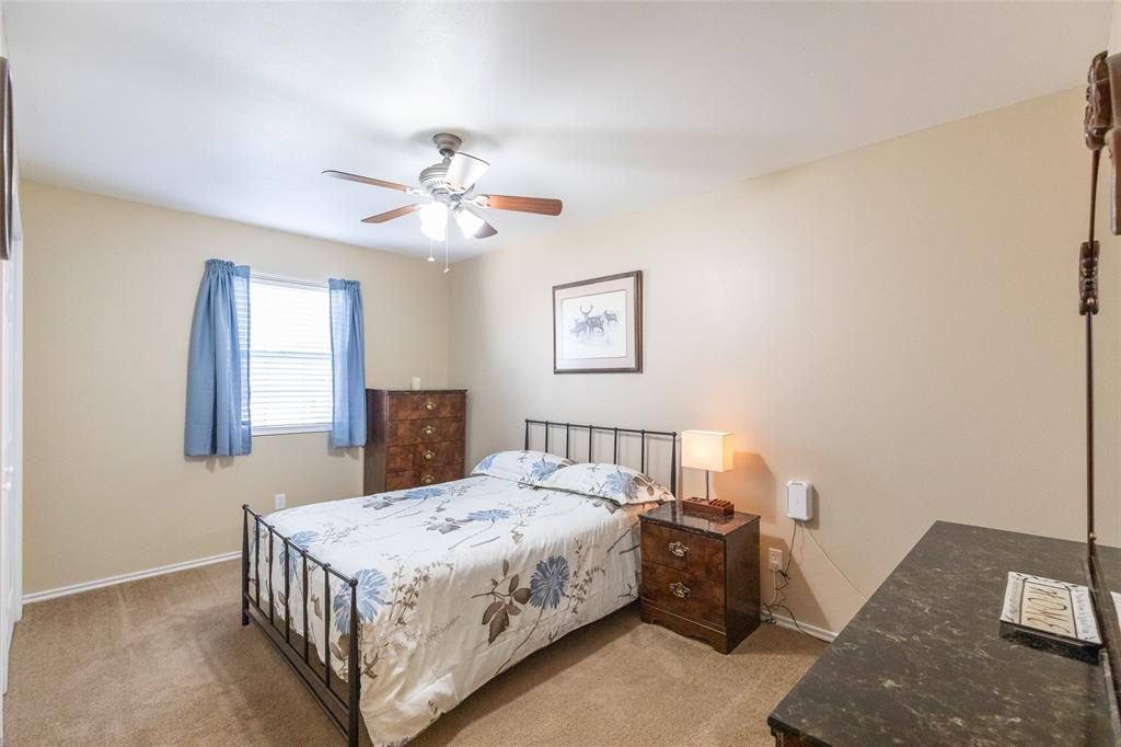 1603 Derrick Drive Haskell, TX 79521 - Photo 22 of 37 a bedroom with a bed and a chandelier