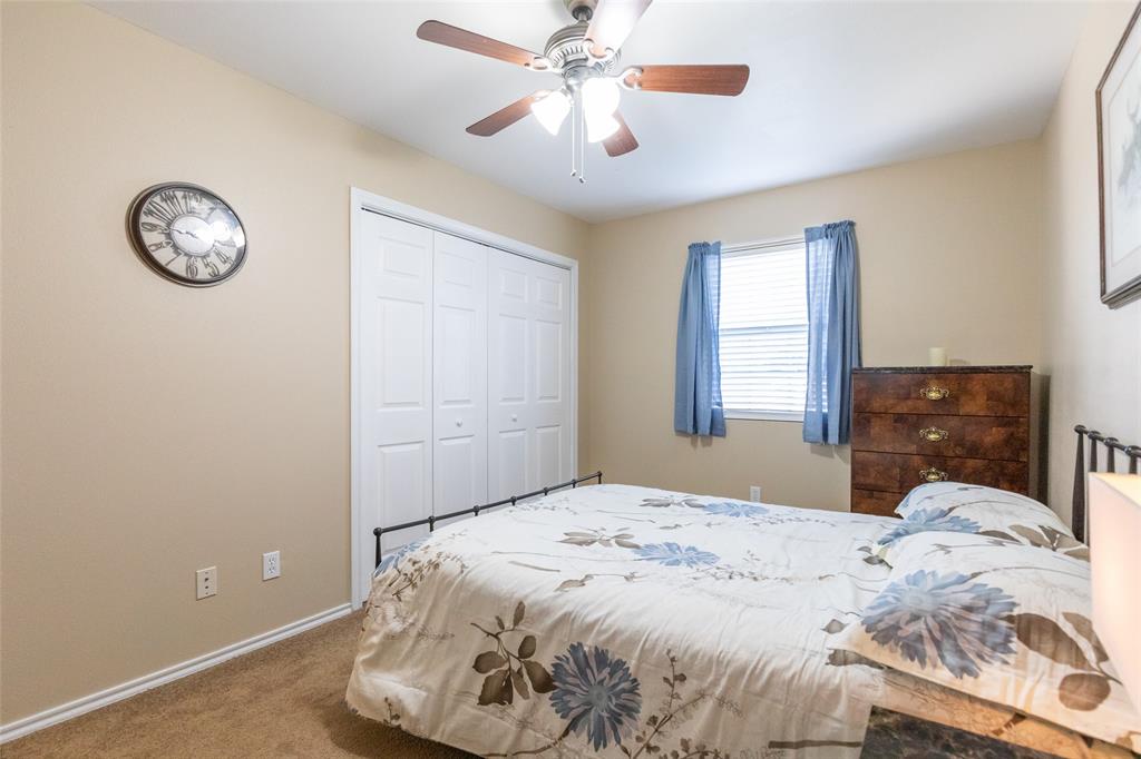 1603 Derrick Drive Haskell, TX 79521 - Photo 23 of 37 a bedroom with a bed and a chandelier