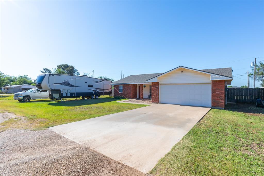 1603 Derrick Drive Haskell, TX 79521 - Photo 36 of 37 a front view of a house with a garden and yard