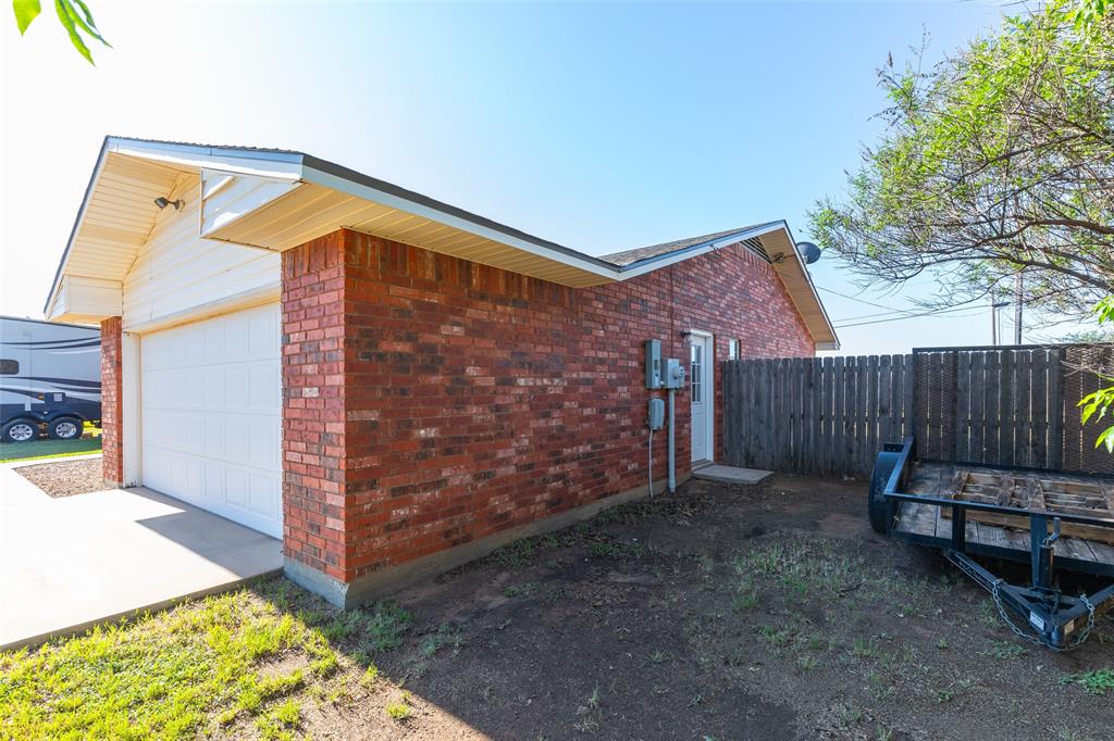 1603 Derrick Drive Haskell, TX 79521 - Photo 37 of 37 a backyard of a house with wooden fence and a bench
