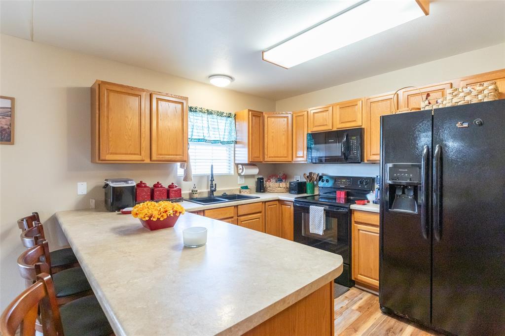 1603 Derrick Drive Haskell, TX 79521 - Photo 9 of 37 a kitchen with a sink a stove and refrigerator