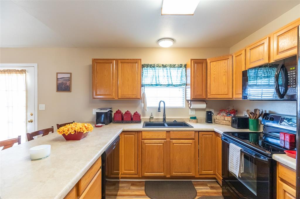 1603 Derrick Drive Haskell, TX 79521 - Photo 10 of 37 a kitchen with stainless steel appliances granite countertop a sink stove and cabinets