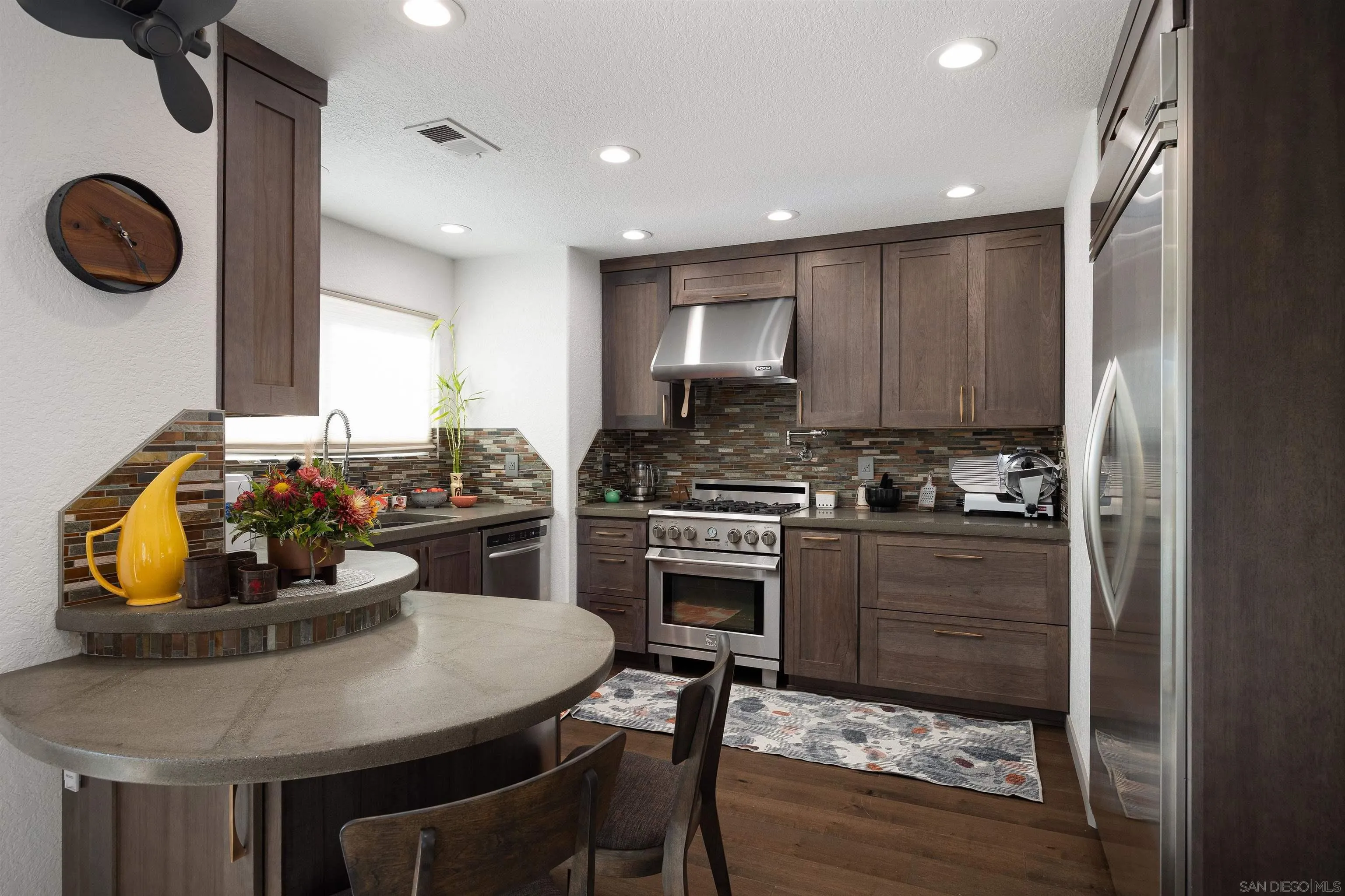13947 Midland Road Poway, CA 92064 - Photo 5 of 22 a kitchen with a dining table cabinets and appliances