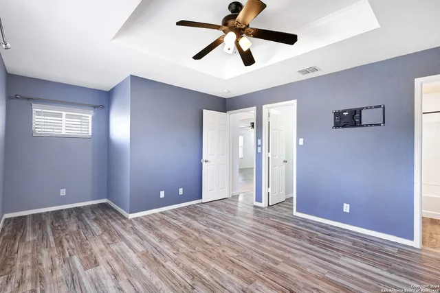a view of empty room with wooden floor