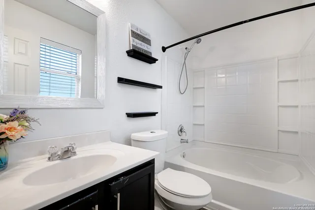a bathroom with a sink a toilet and a bathtub