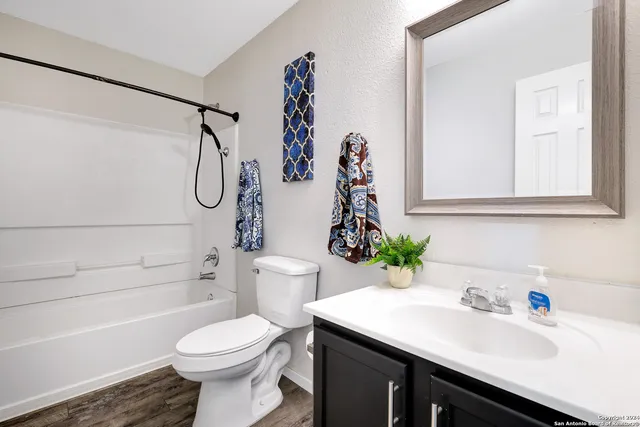 a bathroom with a sink toilet and shower
