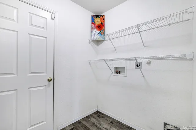 a view of storage and utility room with racks on the wall