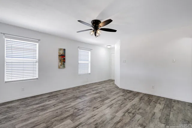 a view of a livingroom with a window and a ceiling fan