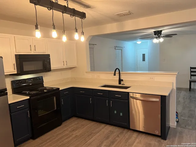 a kitchen with a sink and cabinets