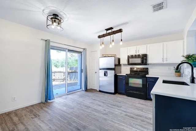 a kitchen with stainless steel appliances a refrigerator microwave and sink