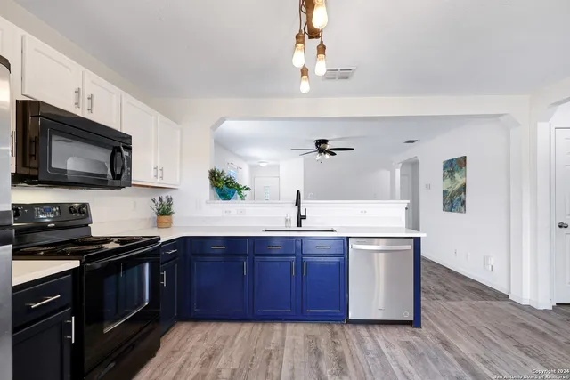 a kitchen with a sink stove and microwave