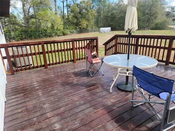 a view of a two chairs and table on the wooden floor