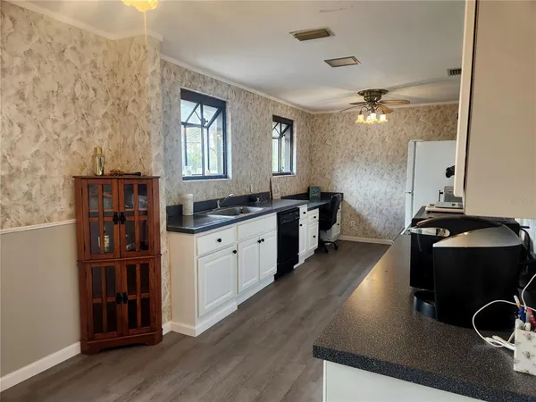 a kitchen with a refrigerator and a stove top oven