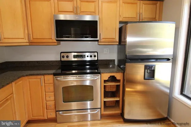 a view of room with a ceiling fan and wooden floor