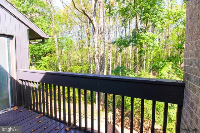 an empty room with wooden floor and window