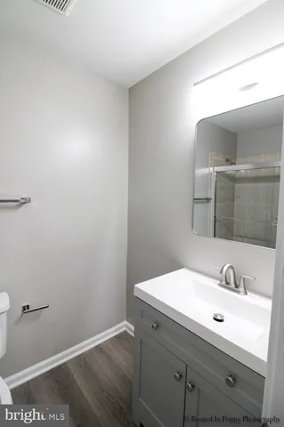 an empty room with wooden floor and door