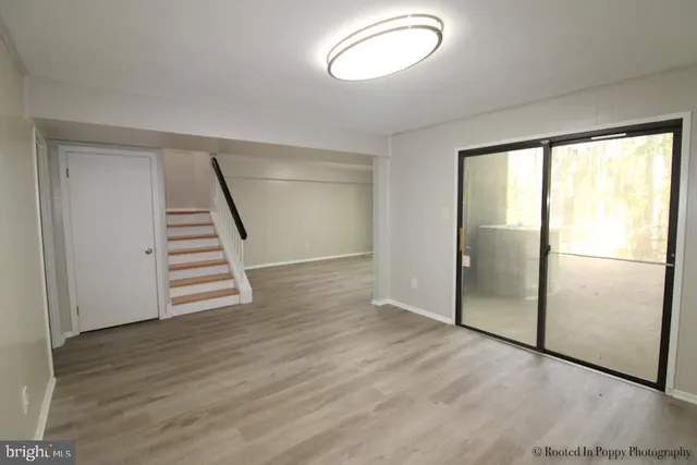 a view of a room with wooden floor