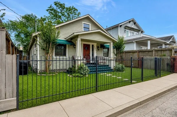 a view of a front of house with a small yard