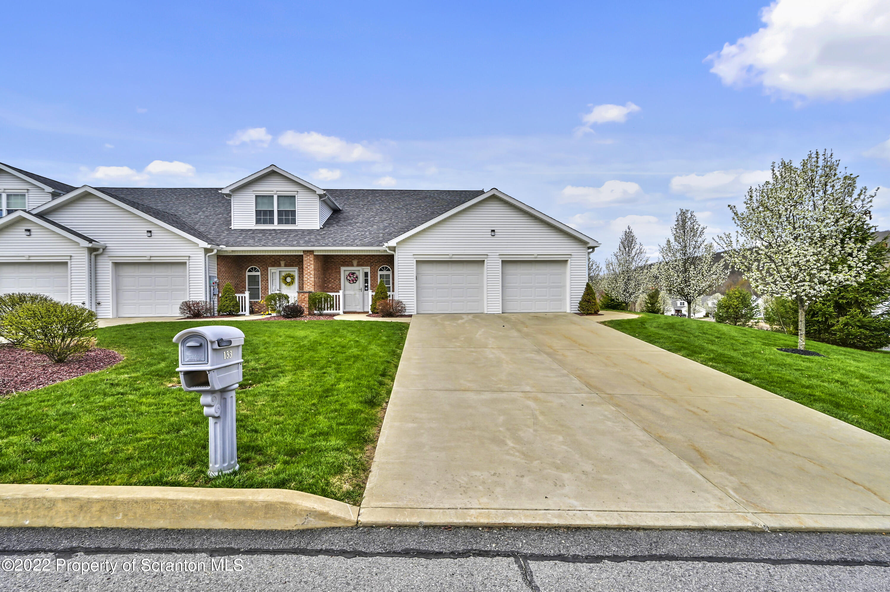a front view of houses with yard