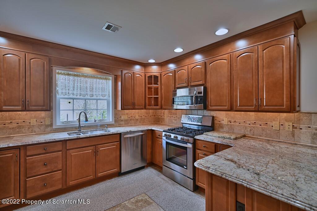 133 Pierce Street Eynon, PA 18403 - Photo 14 of 55 a kitchen with stainless steel appliances granite countertop wooden cabinets a sink and dishwasher