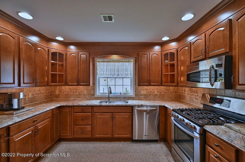 133 Pierce Street Eynon, PA 18403 - Photo 15 of 55 a kitchen with stainless steel appliances granite countertop a sink stove and cabinets