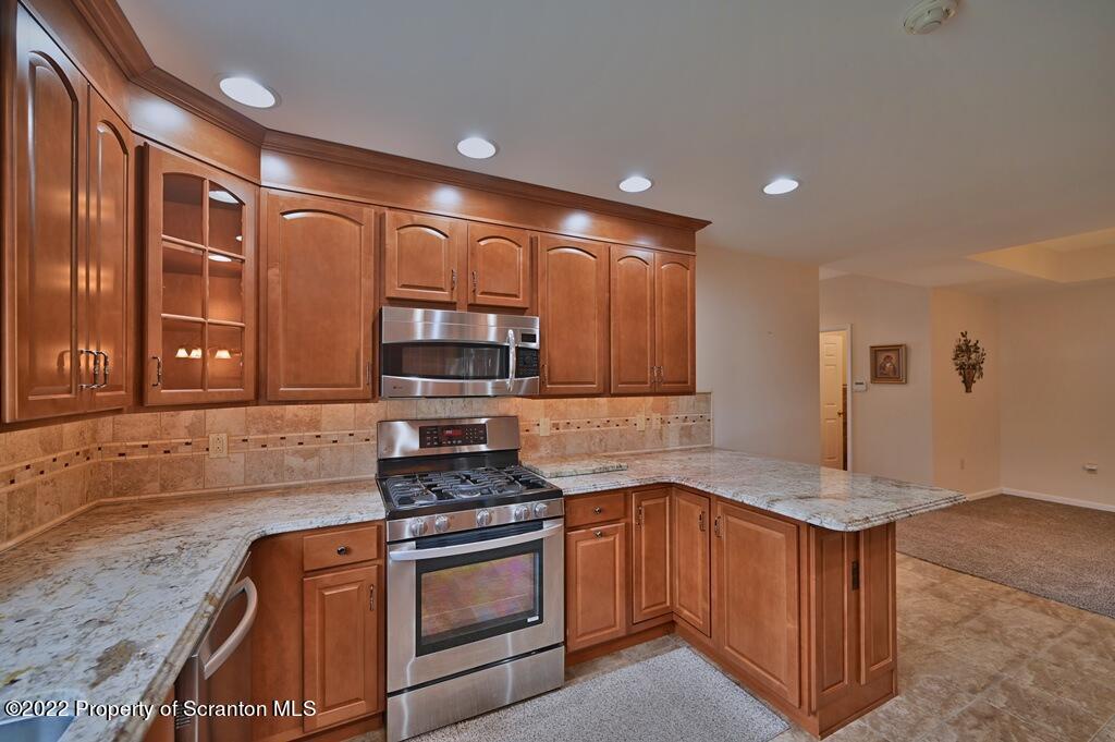 133 Pierce Street Eynon, PA 18403 - Photo 18 of 55 a kitchen with stainless steel appliances granite countertop a stove a sink and a microwave