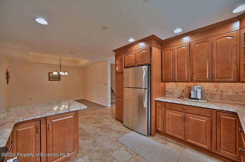 133 Pierce Street Eynon, PA 18403 - Photo 19 of 55 a kitchen with stainless steel appliances granite countertop a refrigerator and a sink