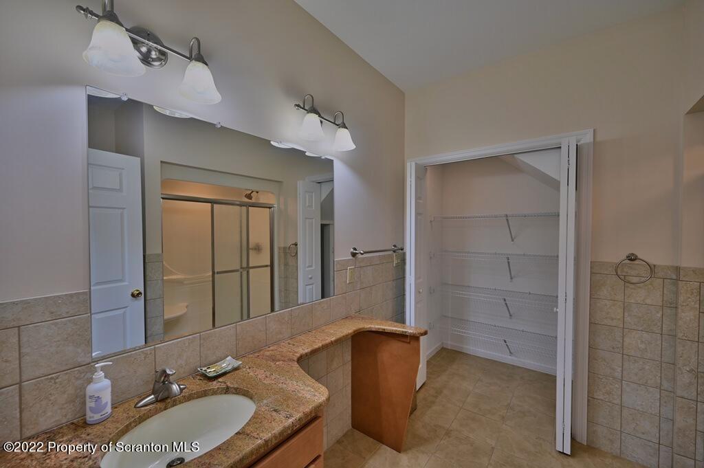 133 Pierce Street Eynon, PA 18403 - Photo 29 of 55 a bathroom with a granite countertop sink and a mirror