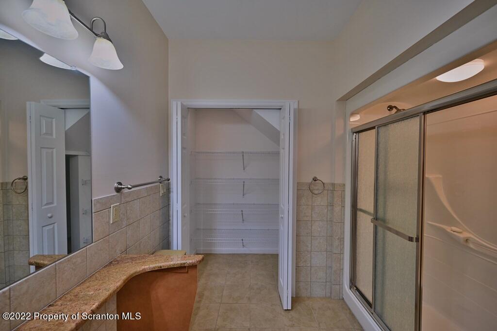 133 Pierce Street Eynon, PA 18403 - Photo 30 of 55 a bedroom with a bed and a chandelier