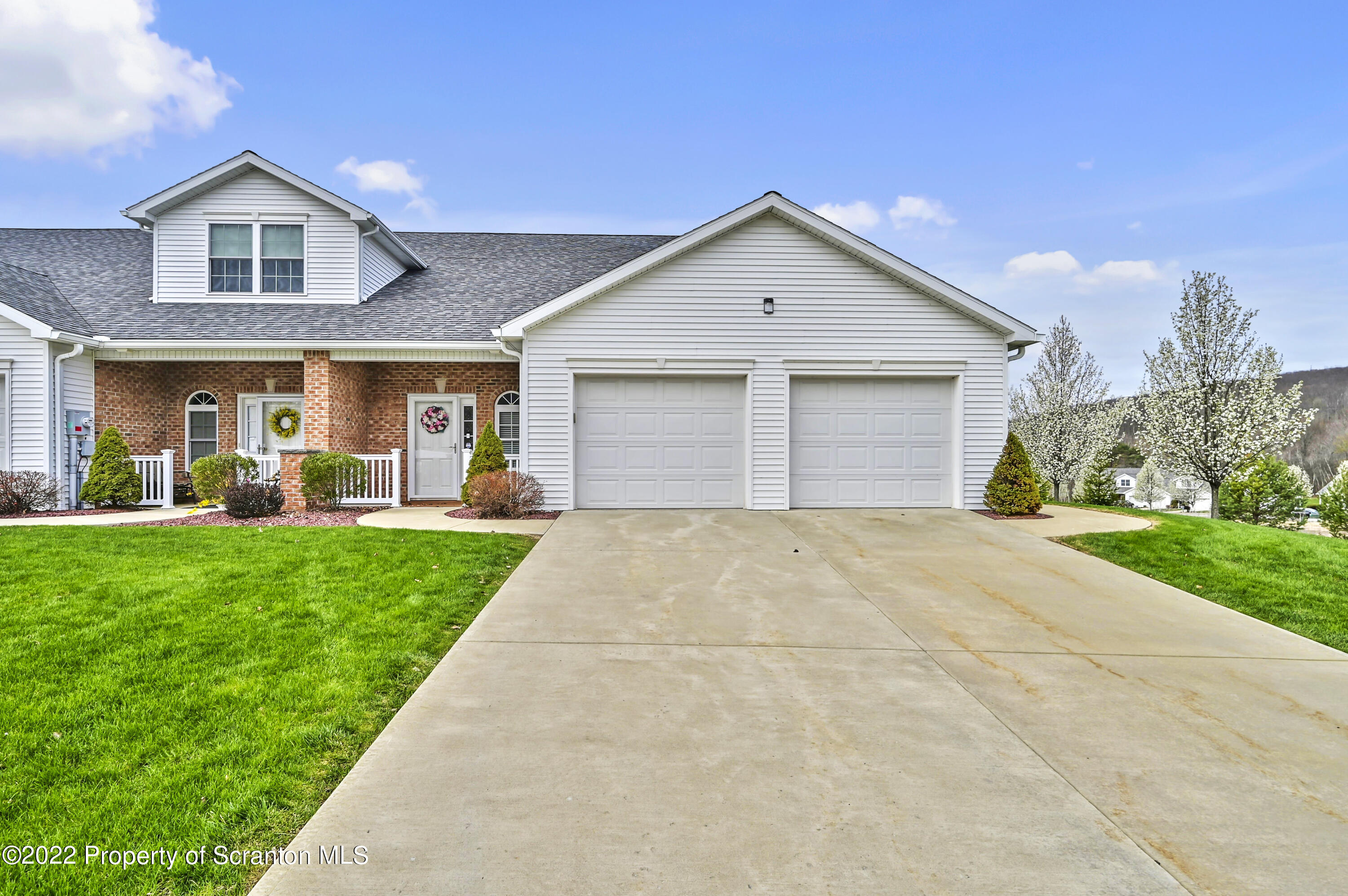 133 Pierce Street Eynon, PA 18403 - Photo 3 of 55 a front view of a house with a yard and garage