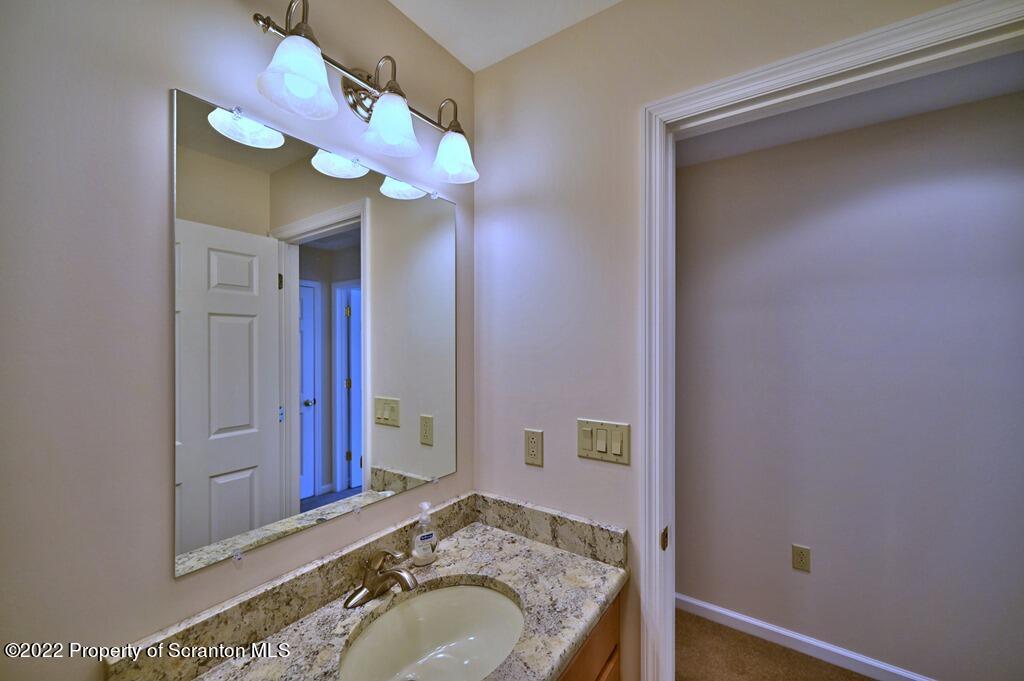 133 Pierce Street Eynon, PA 18403 - Photo 44 of 55 a bathroom with a granite countertop sink and a mirror
