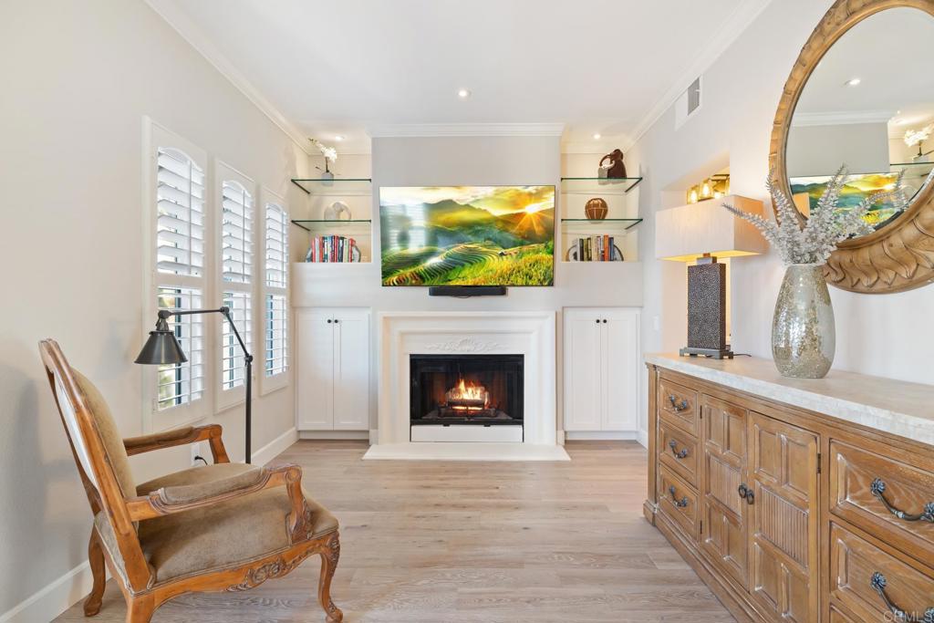 2721 MacKinnon Ranch Road Cardiff-by-the-Sea, CA 92007 - Photo 17 of 38 a living room with furniture a fireplace and a flat screen tv