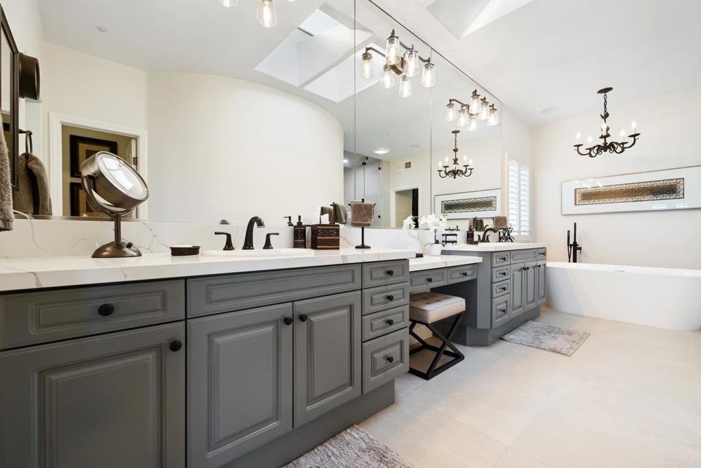 2721 MacKinnon Ranch Road Cardiff-by-the-Sea, CA 92007 - Photo 18 of 38 a kitchen with sink cabinets and stove