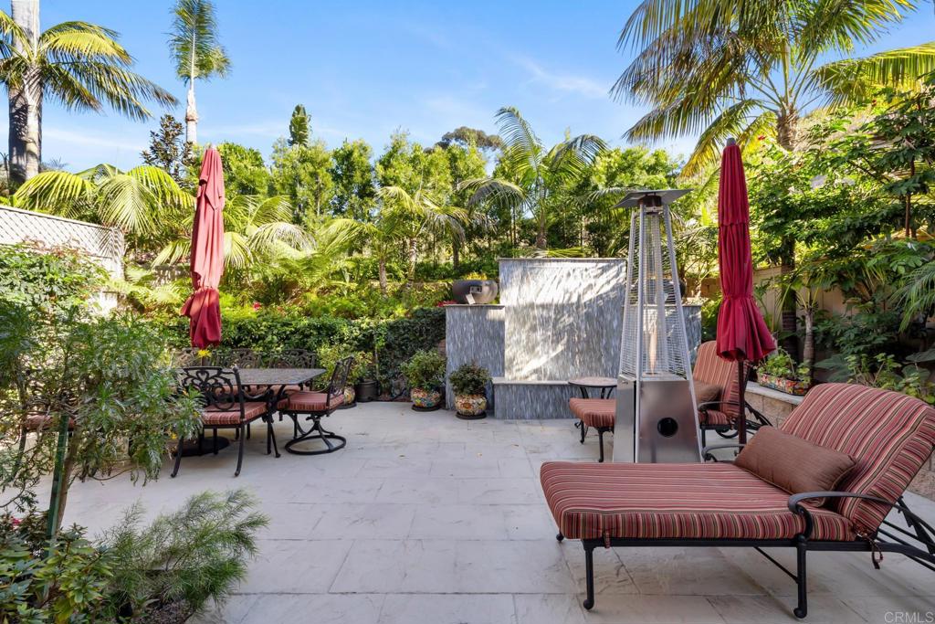 2721 MacKinnon Ranch Road Cardiff-by-the-Sea, CA 92007 - Photo 28 of 38 a backyard of a house with table and chairs
