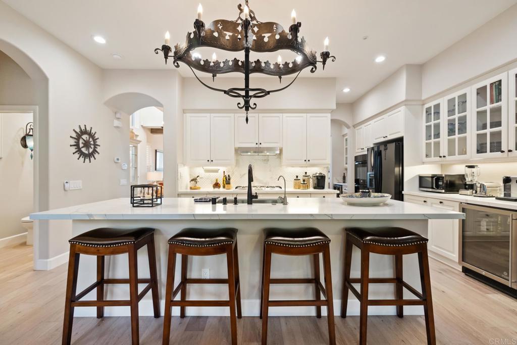 2721 MacKinnon Ranch Road Cardiff-by-the-Sea, CA 92007 - Photo 6 of 38 a kitchen with stainless steel appliances granite countertop a sink and chairs